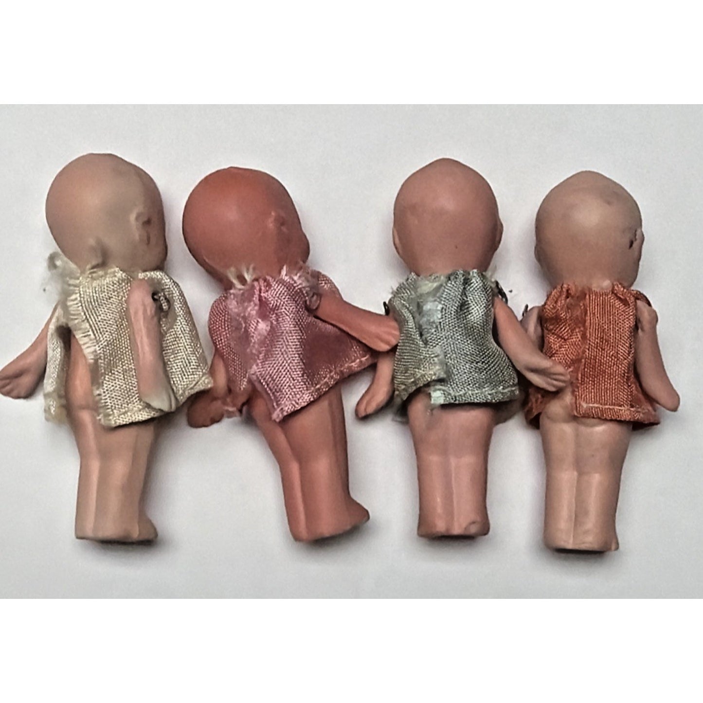 Old Lot of 4 Bisque Porcelain Baby Dolls Miniature Jointed Arms Dresses As Is