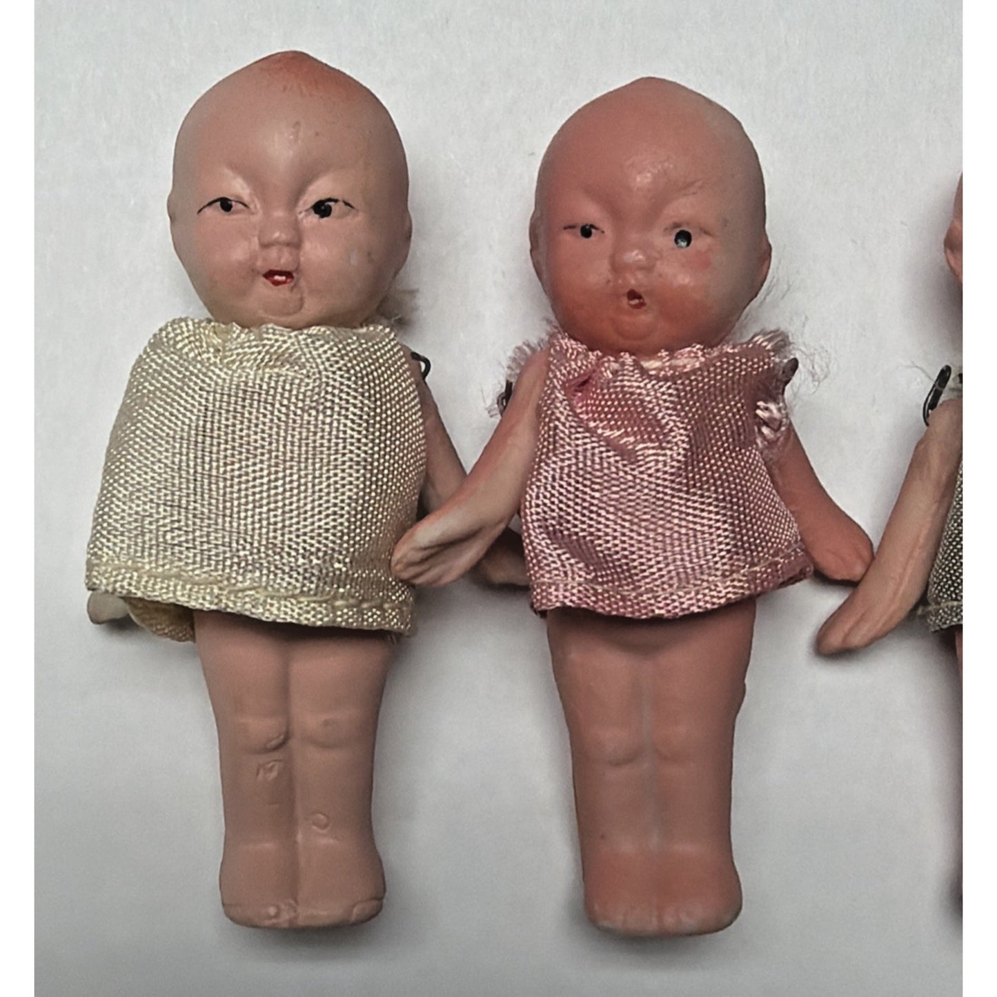 Old Lot of 4 Bisque Porcelain Baby Dolls Miniature Jointed Arms Dresses As Is