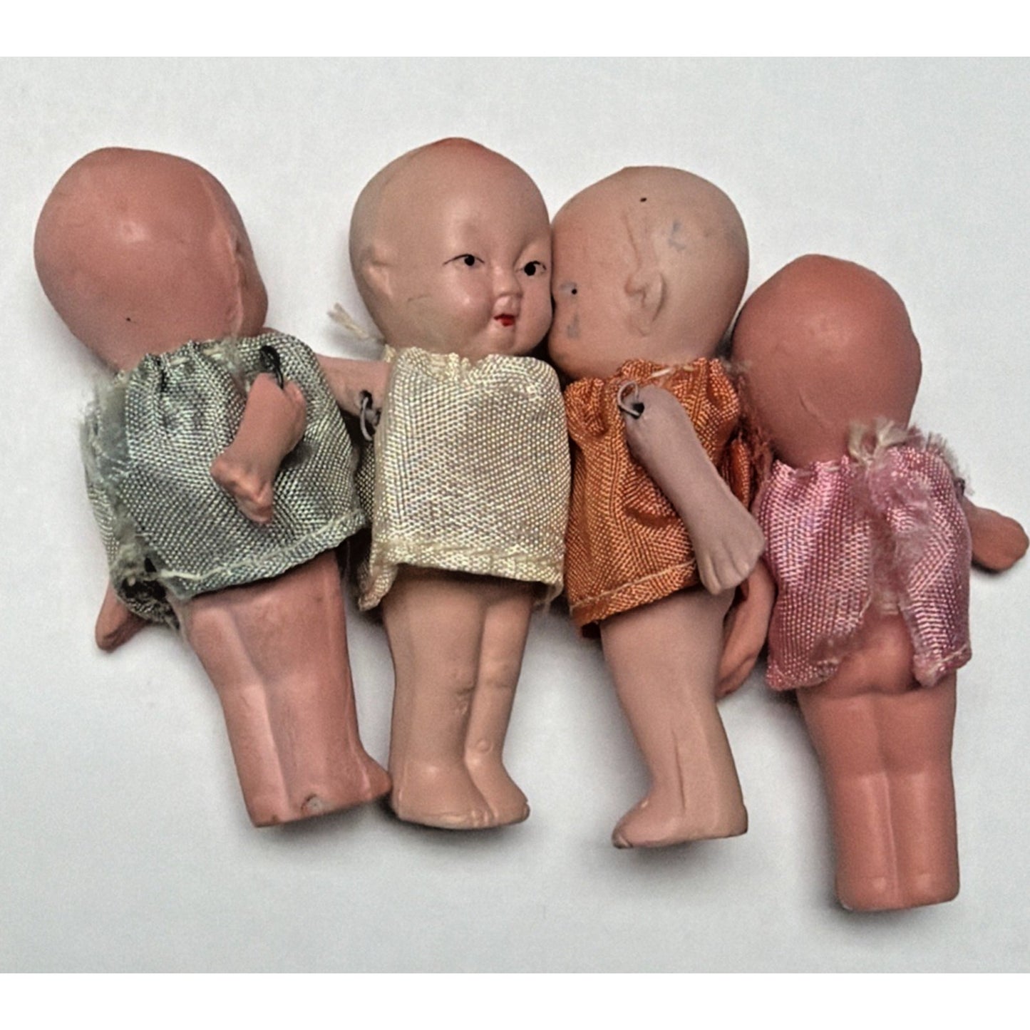Old Lot of 4 Bisque Porcelain Baby Dolls Miniature Jointed Arms Dresses As Is