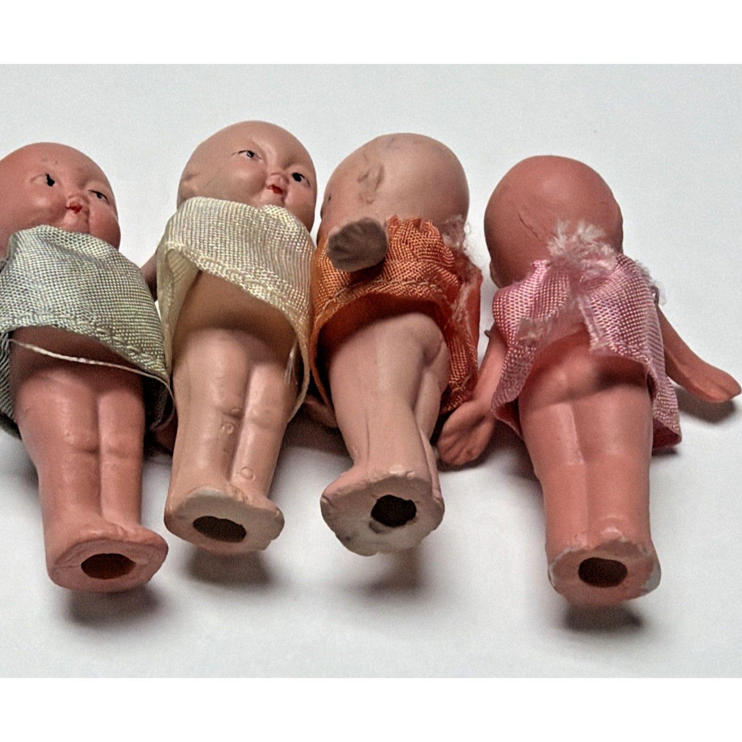 Old Lot of 4 Bisque Porcelain Baby Dolls Miniature Jointed Arms Dresses As Is