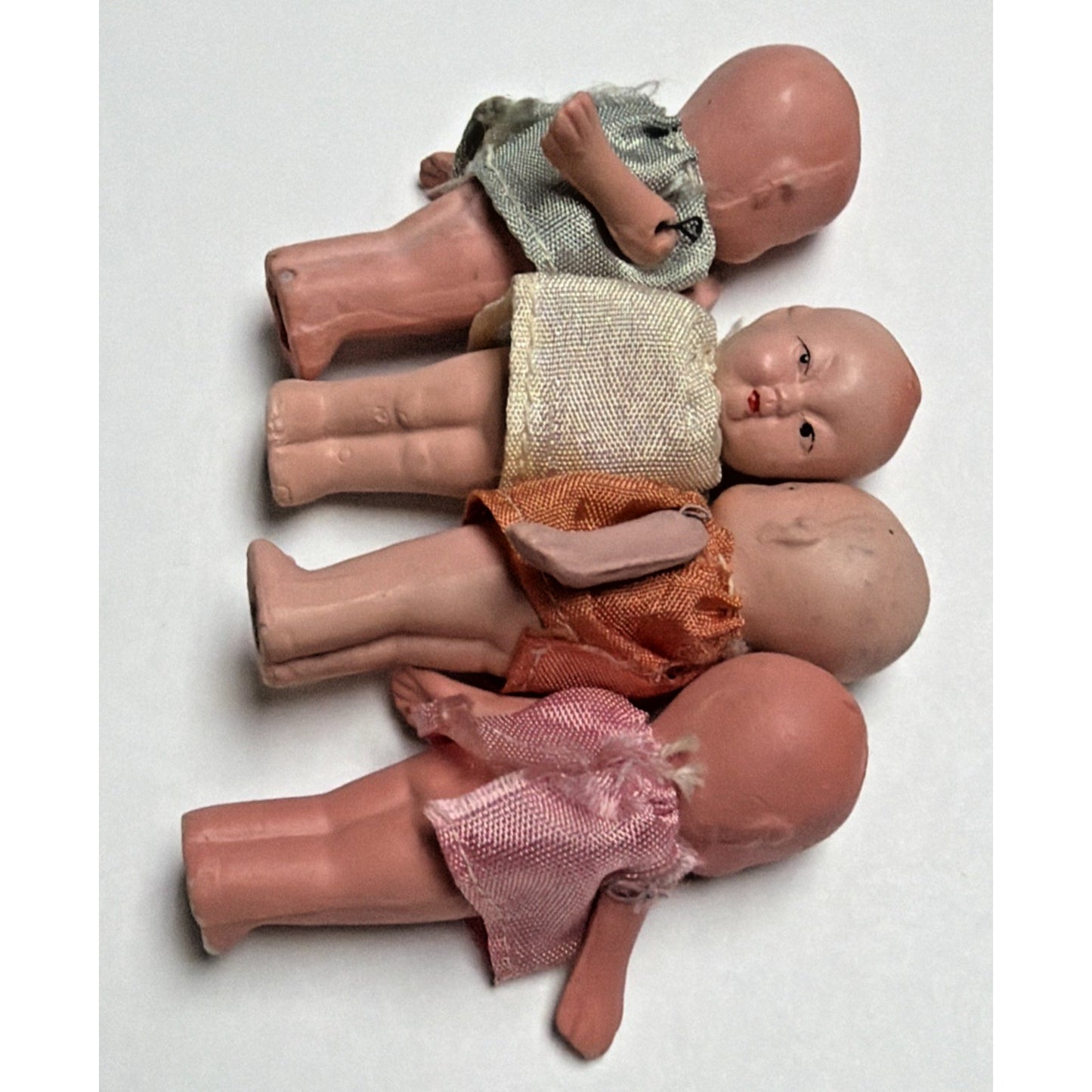 Old Lot of 4 Bisque Porcelain Baby Dolls Miniature Jointed Arms Dresses As Is